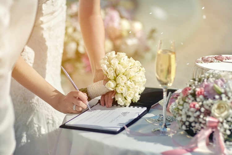 Bride signing document at wedding